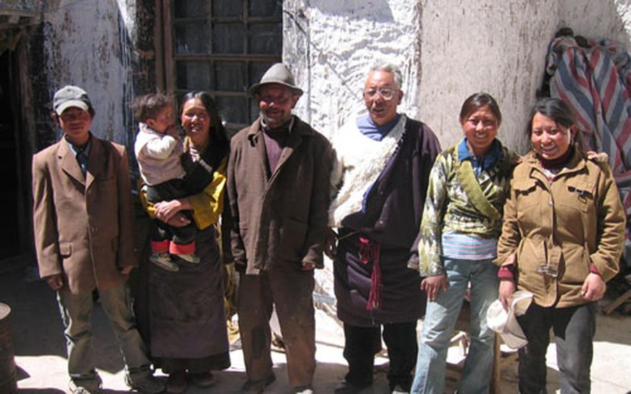 The Tibetan family the Jorgensons visited poses for a photo in the courtyard of their home.