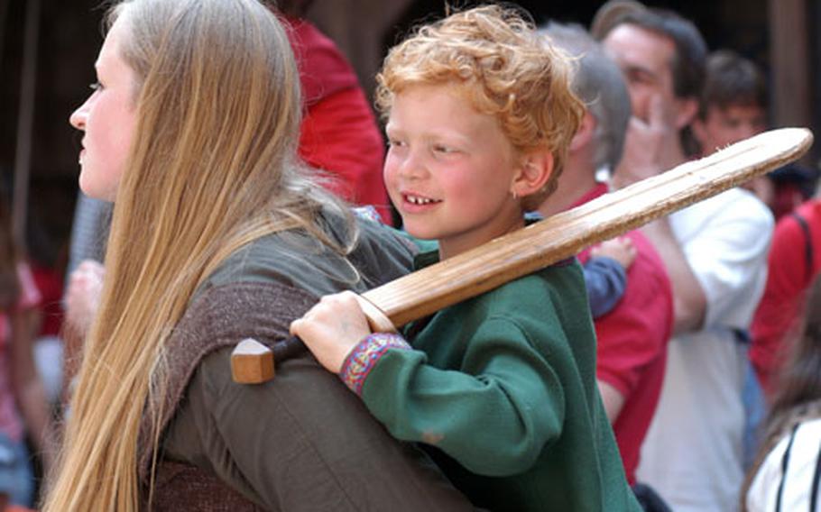 A young knight enjoys the medieval show.