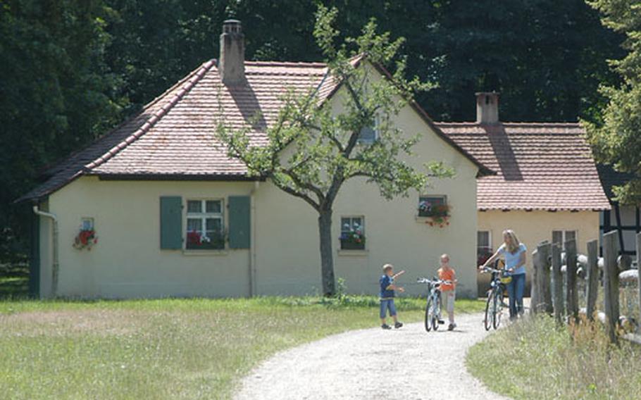 There are many paths to walk and bike on in Schönbusch Park, on the outskirts of Aschaffenburg, Germany. They lead you through the park&#39;s fields, forests and meadows and past its buildings, such as the Palace, the Temple of Friendship, the Philosopher&#39;s House and the tiny village, seen here.