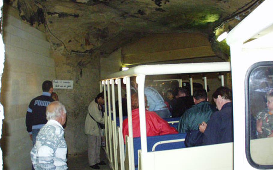 The Municipal Cave in Valkenburg, Netherlands, draws tens of thousands of visitors annually. Visitors to the cave can walk or take a cart train, seen here, which cuts the hourlong foot tour in half.