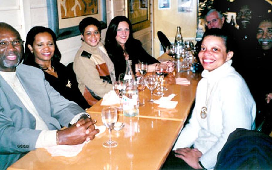 Tour members relax with food and drink at Percy’s Place, advertised as the only black-American-owned restaurant in Paris.