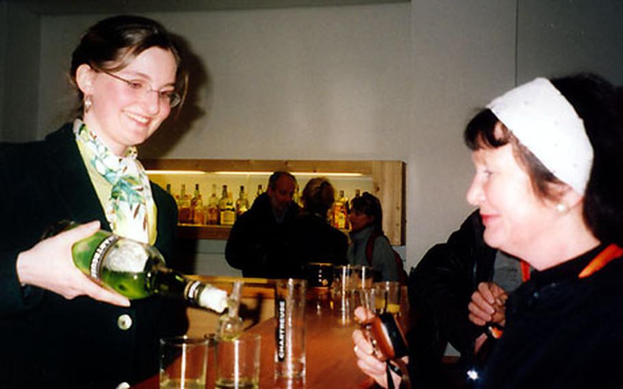 Ludvine Besson, hostess at the Chartreuse monastery, pours a visitor a glass of Chartreuse.