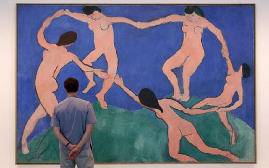A visitor to the MoMA exhibit at the Neue Nationalgalerie in Berlin checks out "Dance (First Version)" by Henri Matisse.