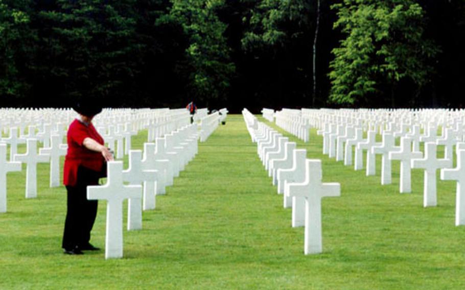 A visitor reads a gravestone at the American Military Cemetery and Memorial in Luxembourg-Hamm. Gen. George S. Patton is among those buried here.