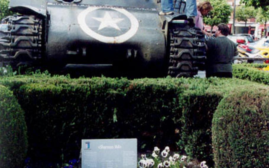 Visitors to Bastogne, Belgium, get a close look at a Sherman M4 tank from World War II.
