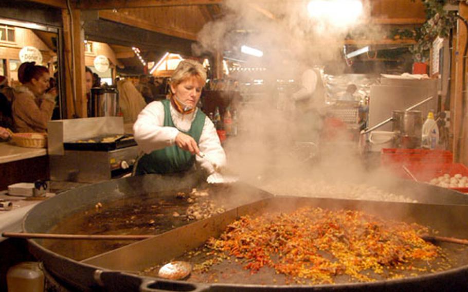 Serving up some hot food on a cold evening at the Erfurt, Germany Christmas market.