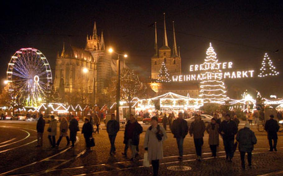 The Erfurt market on the Domplatz, with the Mariendom (cathedral) and the St. Severus church serving as luminous backdrops.