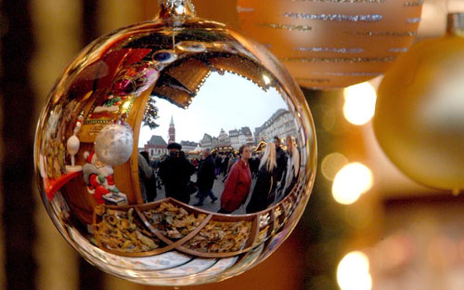 Reflections of the season: An ornament mirrors a scene from the beautiful Christmas market at Frankfurt.