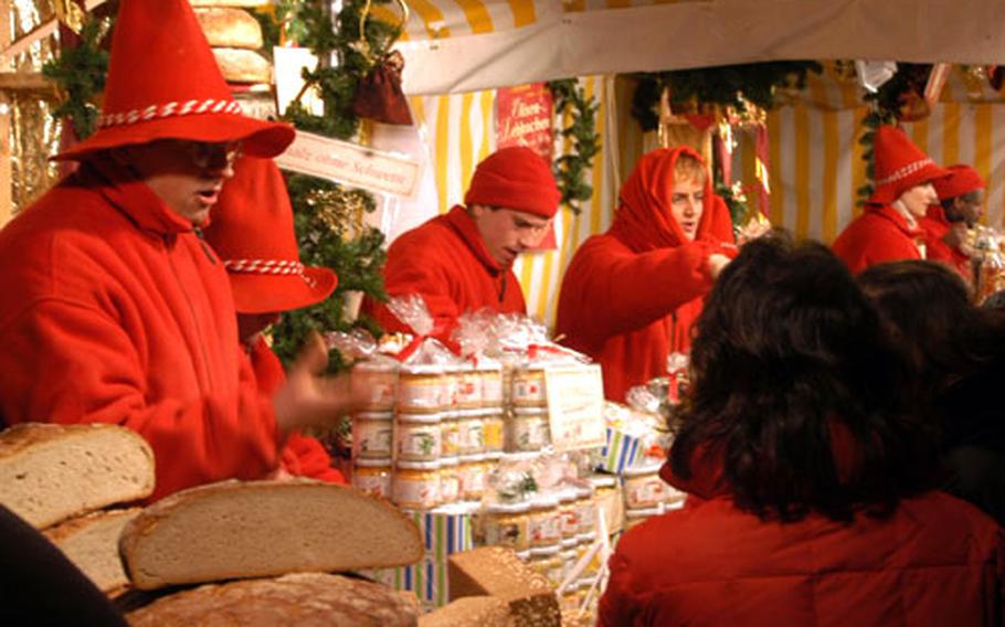 Holiday helpers man a stand selling homemade farm products.