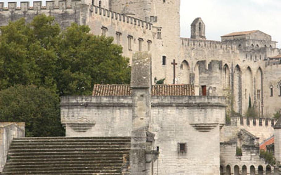 On the St. Bénezet Bridge. The Notre-Dame-des-Doms cathedral and the Palais des Papes (Palace of the Popes) tower above in the background.