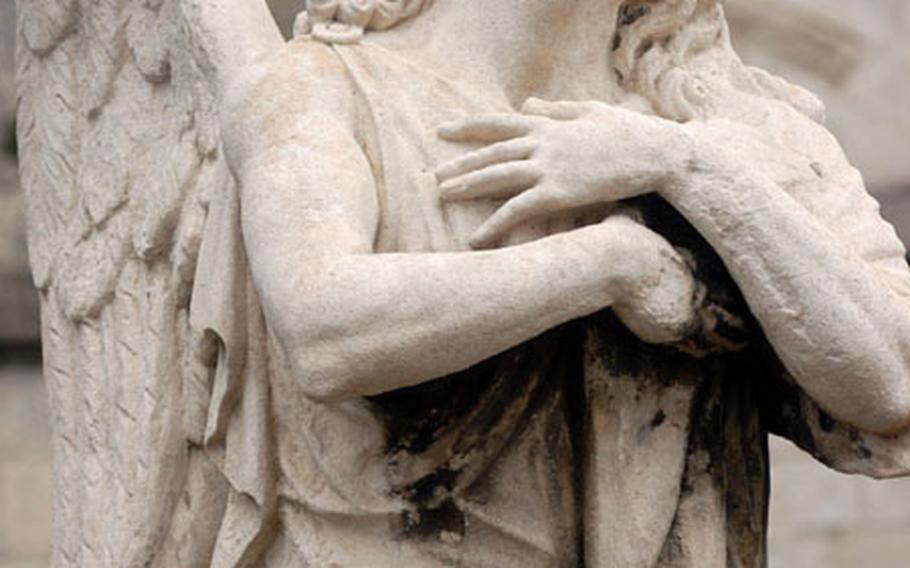 A statue of an angel in front of the cathedral in Avignon.