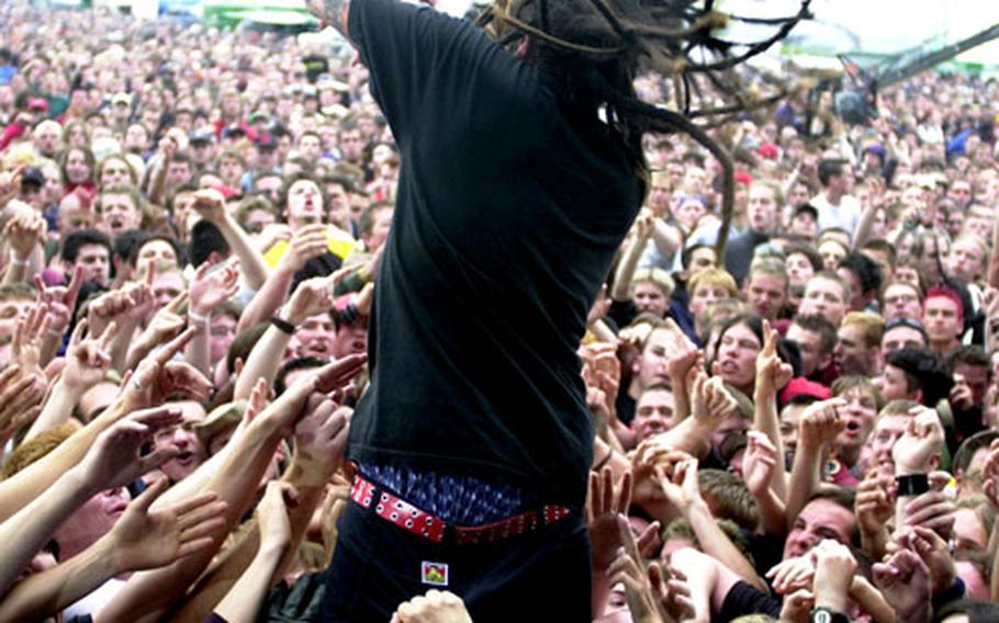 The annual Rock am Ring Festival at the Nurburgring racetrack in Germany assures a lively time; here Sonny Sandoval of P.O.D. jumps into the crowd in May 2002.