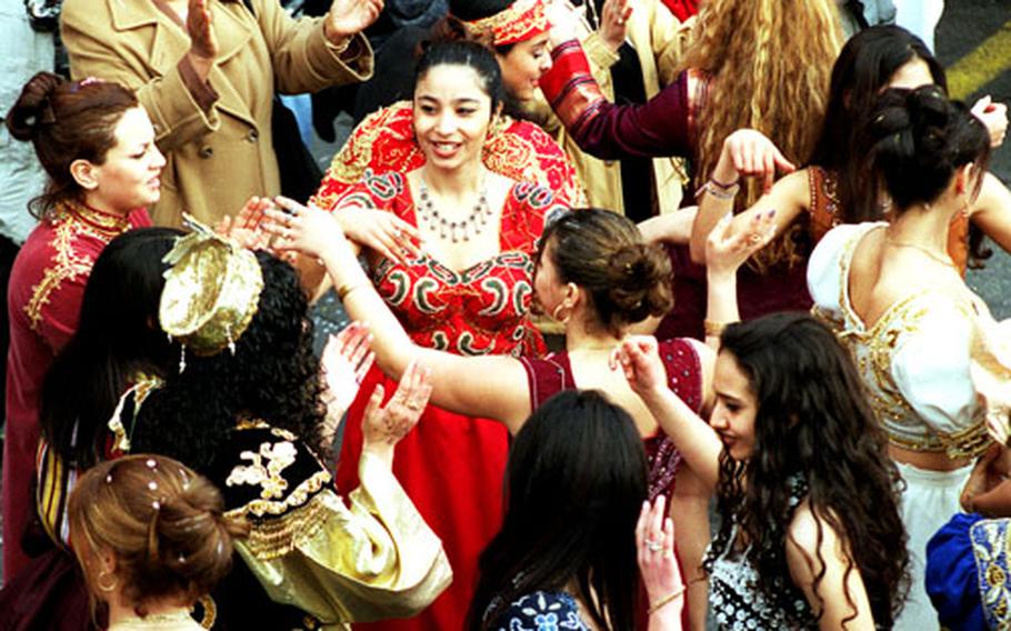 Spanish women dance on the streets of Nice, France, during the Fat Tuesday "Corso Final" parade.