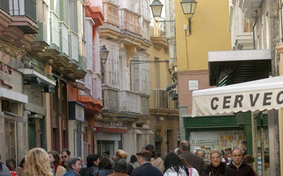Shoppers file through one of the narrow streets in Cadiz where Carnaval revelers will soon take over.