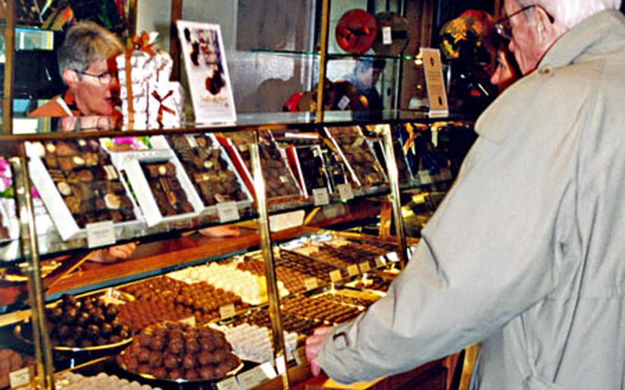 A customer checks out the chocolate at one of Confiserie Sprüngli&#39;s shops in Zurich, Switzerland.