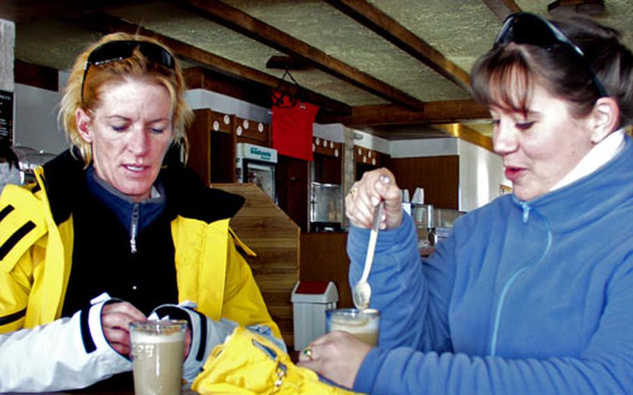 Petty Officer 2nd Class Kathleen Ellison, left, treats Petty Officer 2nd Class Kim Moselle to a cafelatte at the bar at the Roccaraso ski resort.