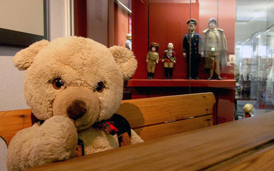 A teddy bear sits at an old-fashioned school desk at the Hessisches Puppenmuseum in Hanau, Germany. Should the kids get restless at the doll museum, toys like the bear are there to entertain them.