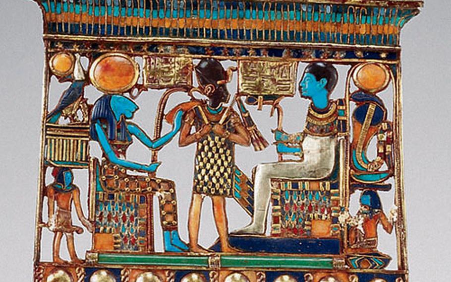 The largest scene in Tutankhamen’s pectoral, or jewelry that hung over the chest, shows the pharaoh standing between the seated Memphite deity couple Sekhmet, left, and Ptah.