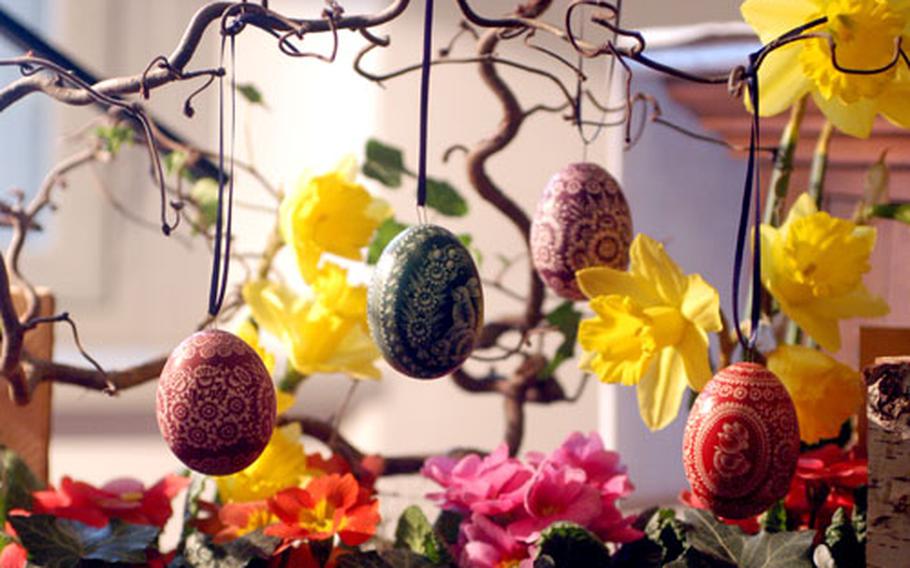 A popular way to display decorated Easter eggs is to hang them on tree branches placed in a vase.