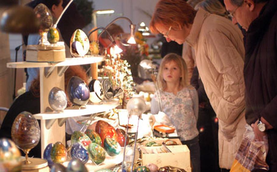 Shoppers check out the goods at the Easter egg market in Seligenstadt, Germany.