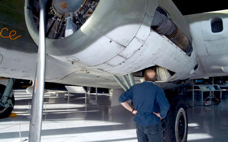 A visitor to the American Air Museum gets a close look at a B-17 Flying Fortress.