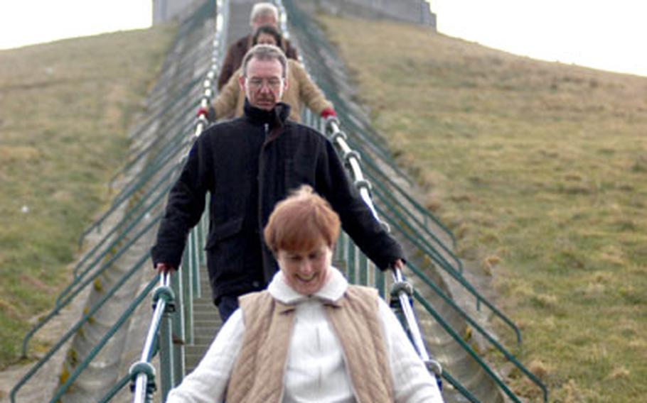 Lion Hill is reached by climbing a 226-step staircase. Working their way down recently was Josephine and John Sutton (foreground) and Sean and Mary Farrell, all of Ireland. The mound and lion were a gift from the Netherlands.
