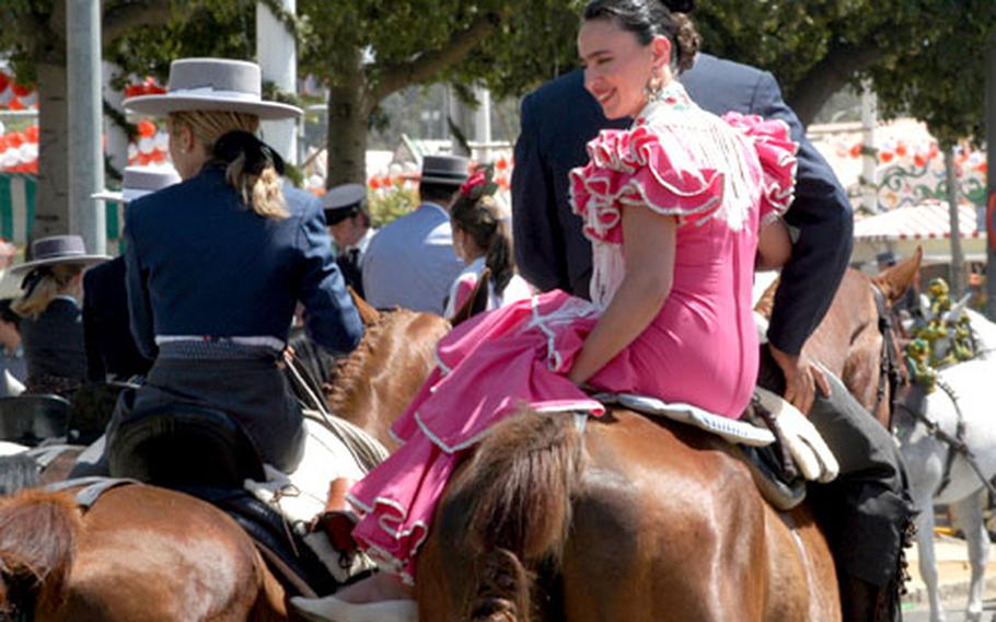 Señoritas in bright colors and the traditional garb of Spain’s horse riders parade through the street on their majestic mounts, making an attractive combination.