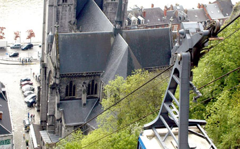 A cable car carries visitors from the Dinant Citadel down to the city center. The one-minute ride offers views of the Meuse River.