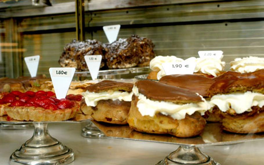 Pastries are displayed in the window of a local bakery. A suggestion for hungry tourists: buy goodies from local stores for a picnic.