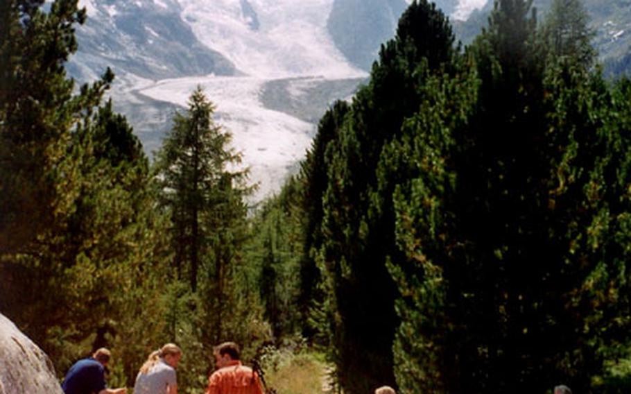 Hikers take a picnic break along the Morteratsch glacier trail.