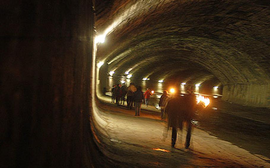 People on the tour carry torches and flashlights as they walk through the dank tunnel that the Wien River flows through. The sewers played a prominent role in the British movie classic “The Third Man.”
