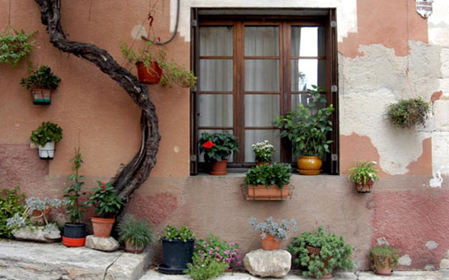 A house decorated with potted plants adds to the charms of St.-Saturin-les-Apt, one of the hilltop villages of the Luberon in France.
