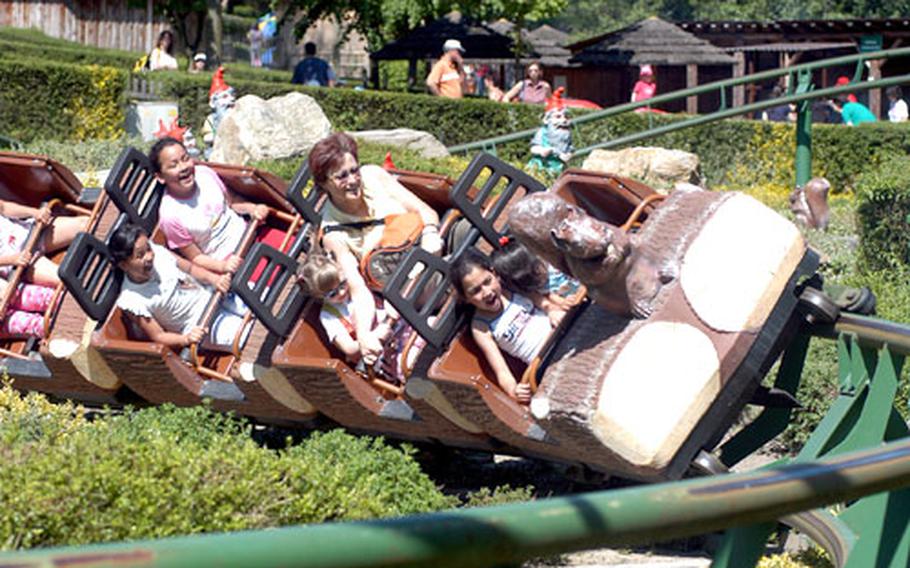 Riders zip around the curve on the “Eichhörnchenbahn” or squirrel train, a small roller coaster-like ride at the Lochmühle amusement park.