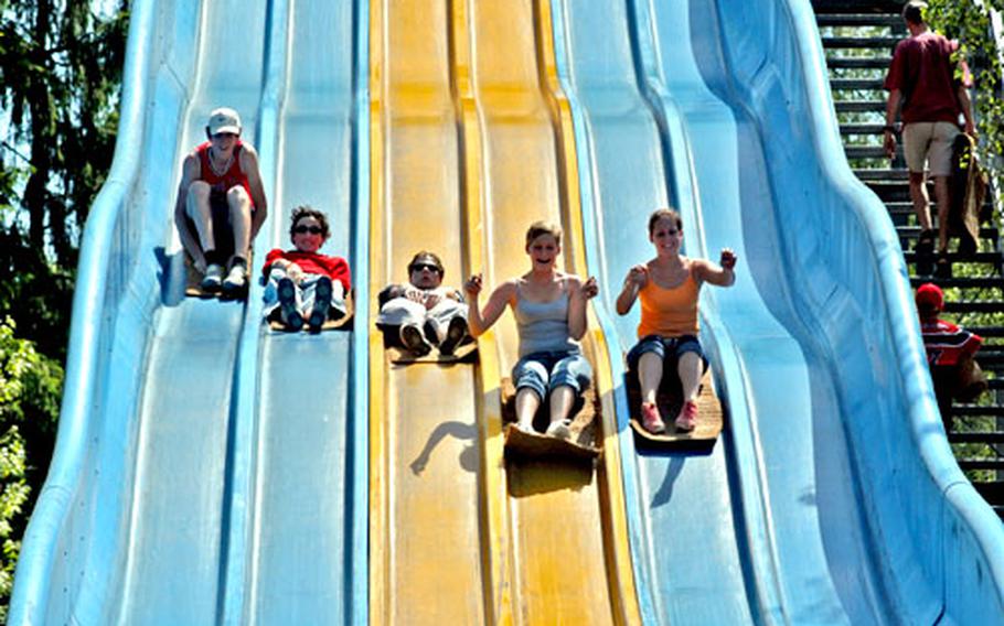 A group of friends ride the mats down the giant slide at the Lochmühle amusement park.