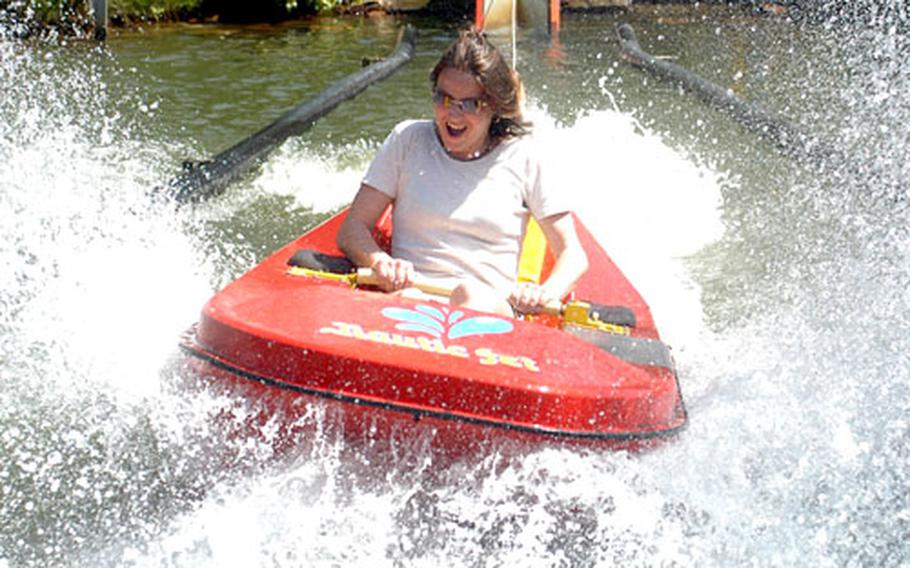 A visitor to the Lochmühle amusement park splashes in on the "Wasserbob," or water bobsled, ride.