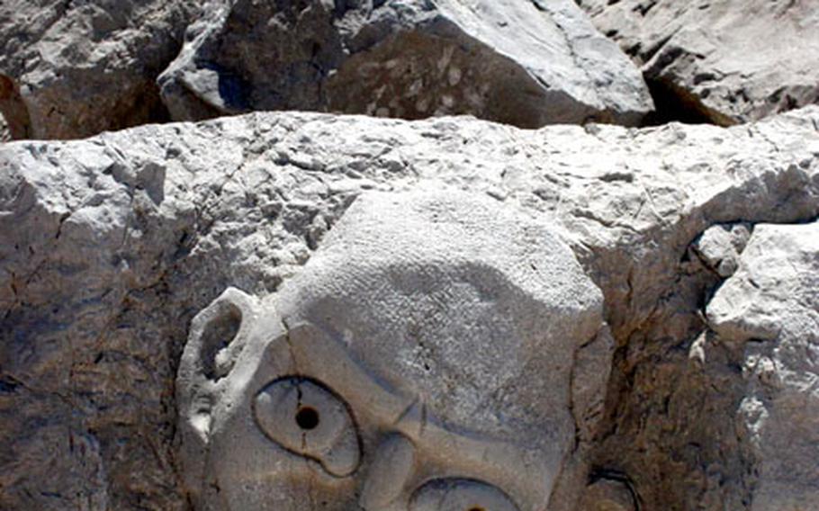 This smiling face is one of dozens carved into rocks along the protective barrier that separates the two main beaches at Caorle.