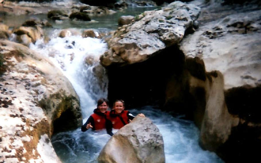 Sarah Andrews and her sister, Mary, take a beak behind a boulder in the middle of a whirlpool while canyoning in Spain&#39;s Parque de la Sierra y los Cañones de Guara.