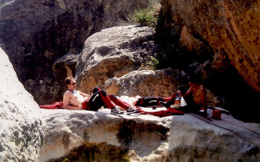 Miquel Torres, the writer’s husband, and Sergio, the canyoning guide, right, take a lunch break in the sun before continuing down the Río Vero.