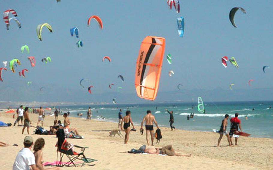Shimmering "chutes" fill the sky over a beach near Tarifa.