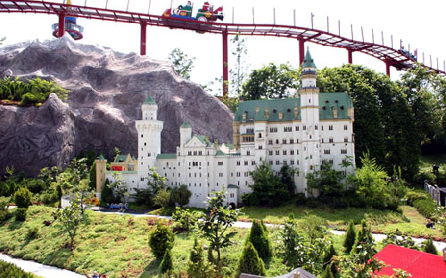 A replica of Germany&#39;s famous Neuschwanstein Castle sits below a ride at the Legoland Deutschland amusement park. This version is constructed from 300,000 Lego building bricks.