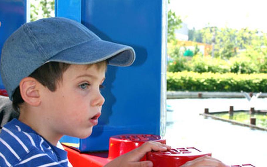 Ryan Carlsson, age 3, looks out the window as he rides the train at the Legoland Deutschland amusement park in Germany, between Stuttgart and Munich.