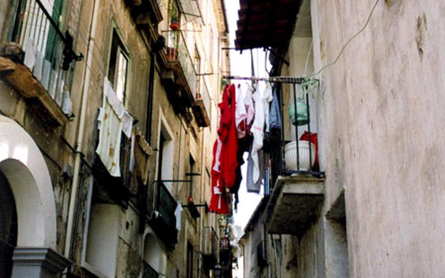 The old town of Cosenza in Calabria is downtrodden, with crumbling buildings and dark alleyways.