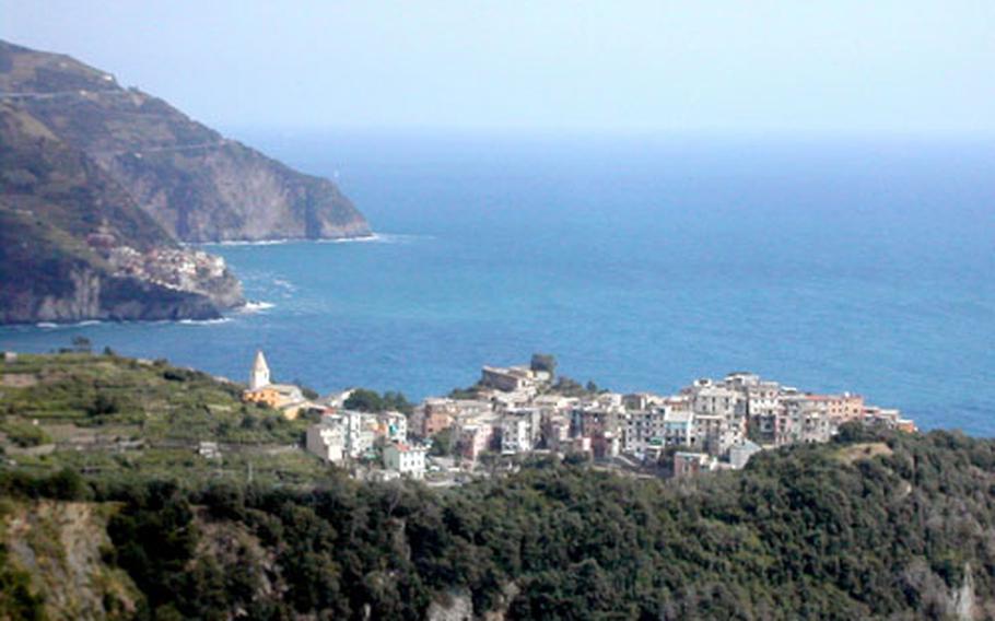 A series of trails high above the sea binds these colorful towns like beads on a string. Corniglia is shown here, with Manarola in the distance. Manarola lends itself to cliff-diving into deep water.