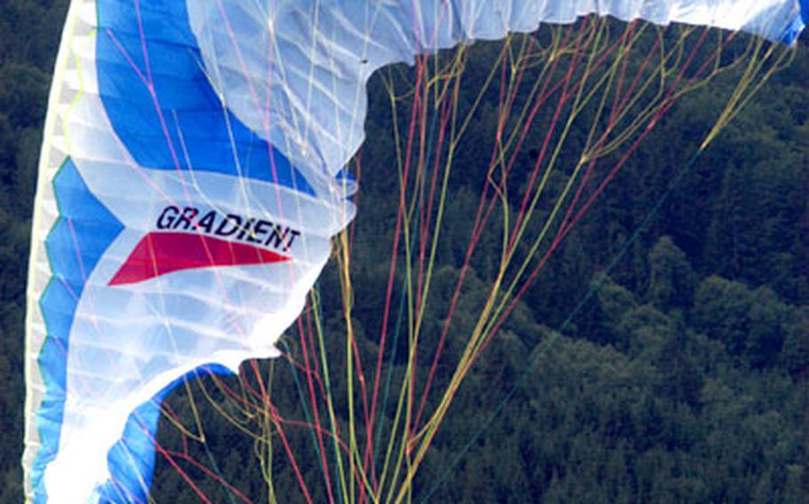 Jason Brock gets his feet back on terra firma after a paragliding with an instructor in Garmisch.