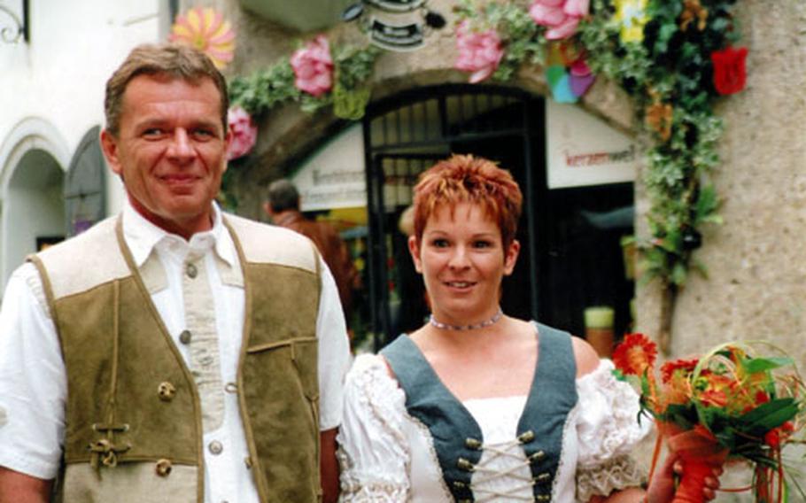 A bridal couple wearing the traditional costume obligingly allow tourists in Innsbruck to take their photo.