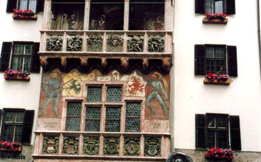 A silver-painted street performer poses for photos in front of the famous Goldenes Dachl, or “little golden roof,” in Innsbruck.