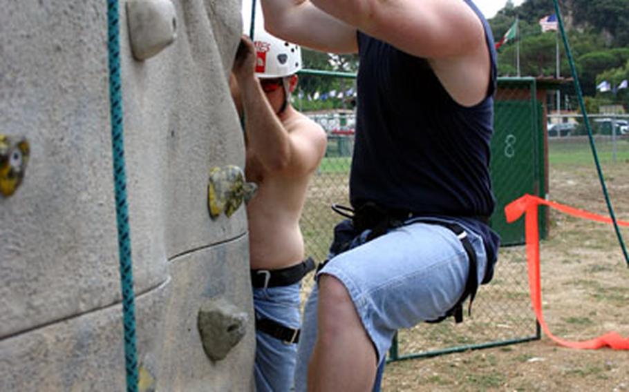 Petty Officer 2nd Class Gary Keen, 26, takes a shot at climbing the rock wall at Carney Park, the U.S.-Navy run recreational facility at Naples, Italy.
