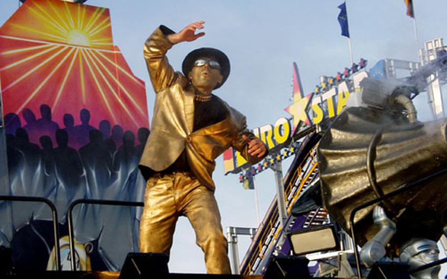 A mime tries to lure customers into one of the high-tech fun houses during last year’s Oktoberfest in Munich.