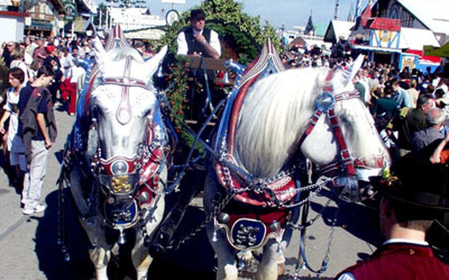 A horse-drawn carriage pulls a giant, wooden keg of beer during a parade marking the first hours of the 2004 Oktoberfest.