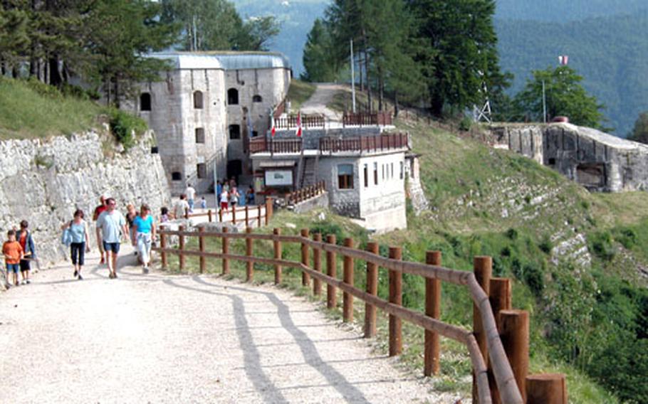 An old military road cut into a limestone spur leads to Forte Belvedere, whose casemate rises from the hillside.